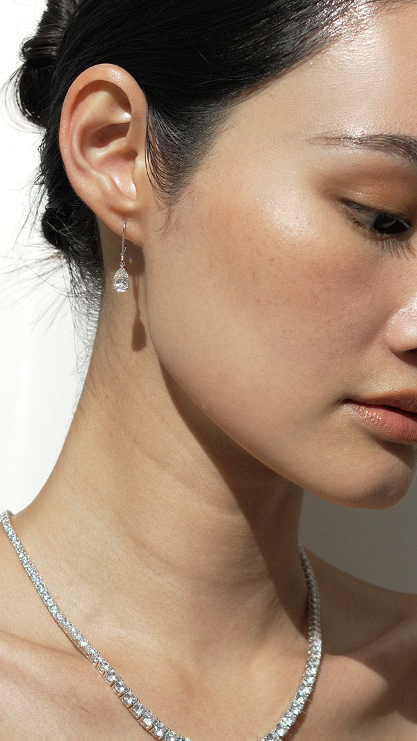 Formal pear drop solid white gold earrings for women.
