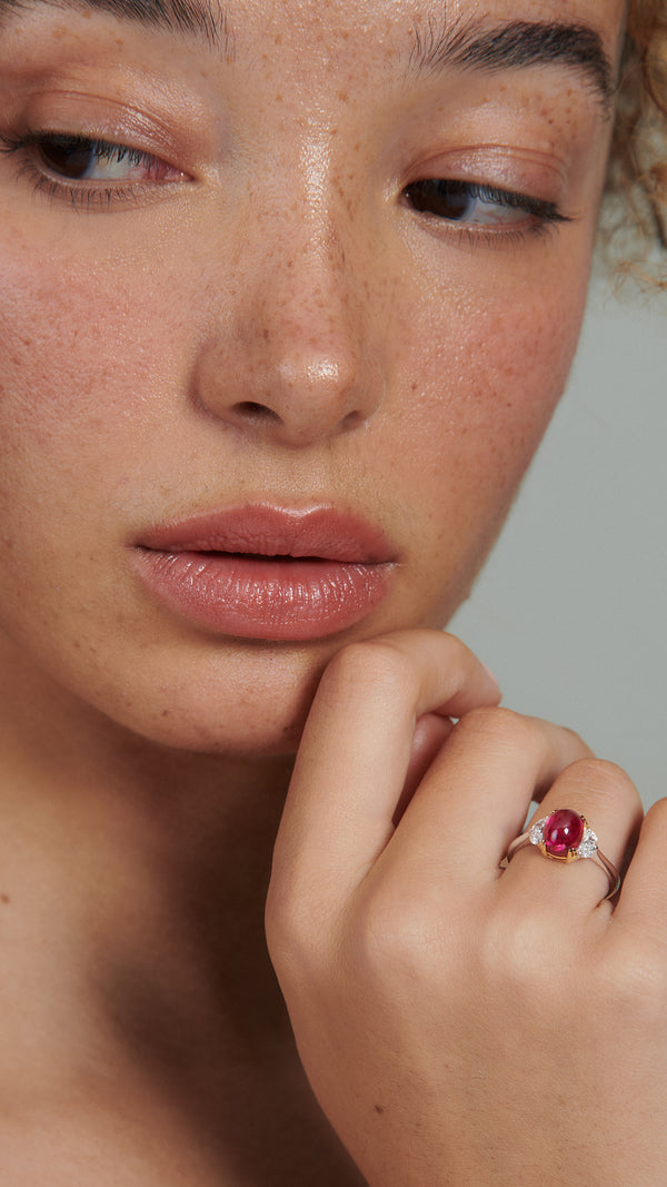 Unique solitaire ring featuring lab-grown Ruby from recycled gemstones. Accented with half-moon lab grown diamonds . Lab-created, sustainable design.