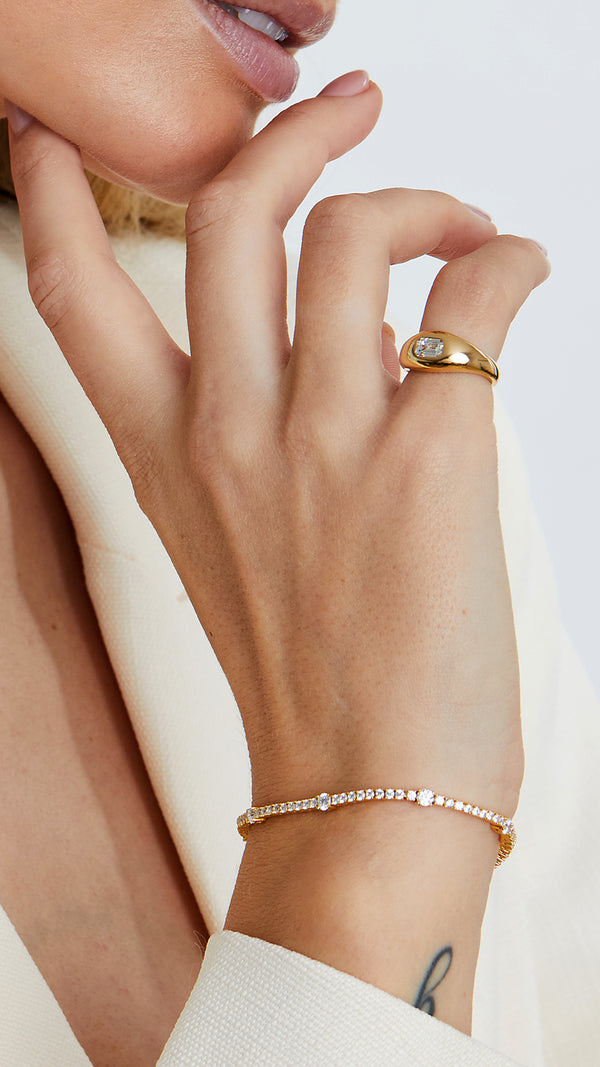 Gold tennis bracelet womens style featuring sparkling diamond-style stones and adjustable fit