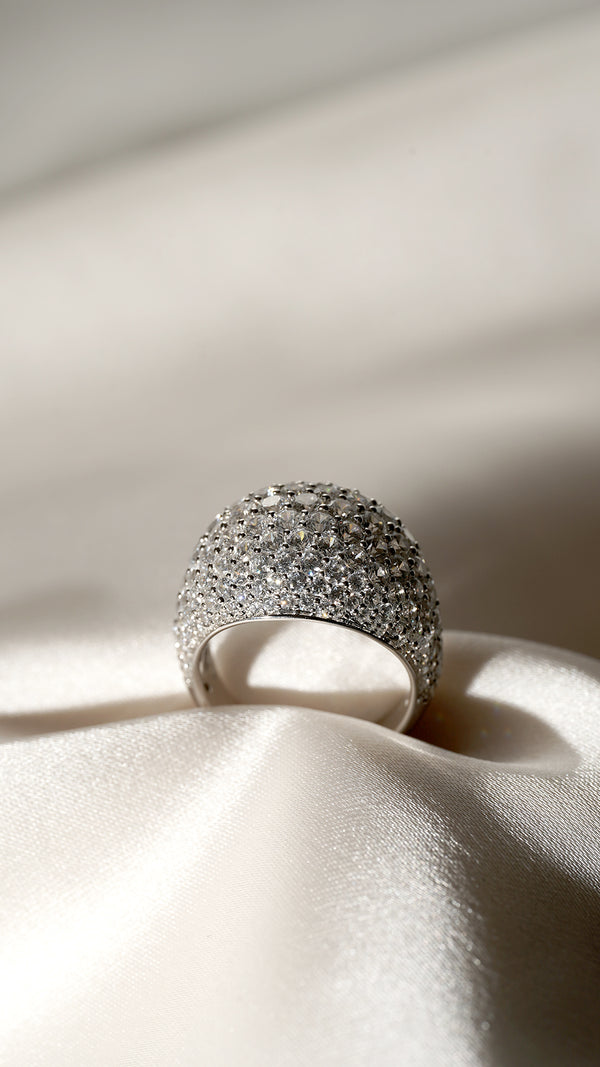 Close-up of a sterling silver pave dome ring with a white gold finish, highlighting the intricate details and sparkling pave stones