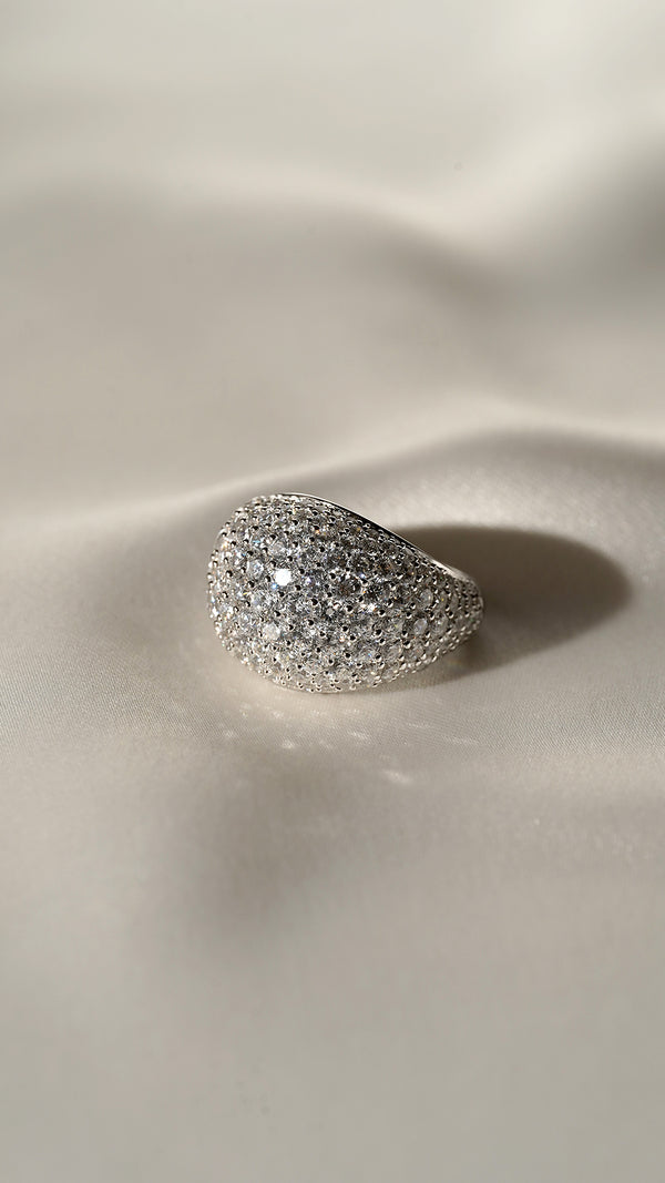 Close-up of the Reese sterling silver dome ring, featuring a shimmering pave surface and a sleek, polished silver gallery.