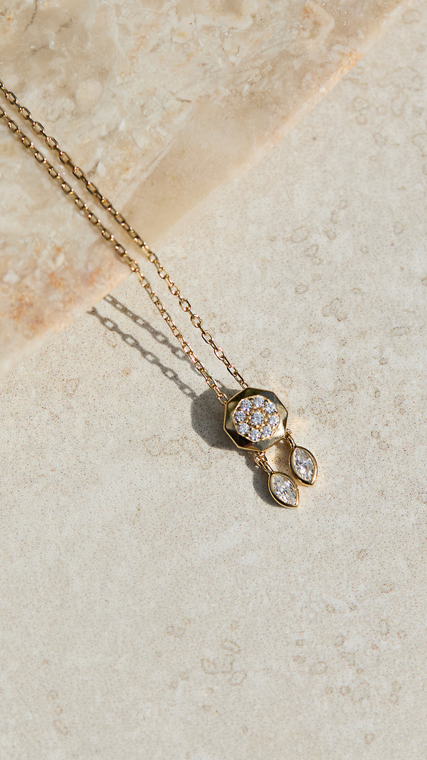 Delicate gold necklace with a decorative adjustable slider.