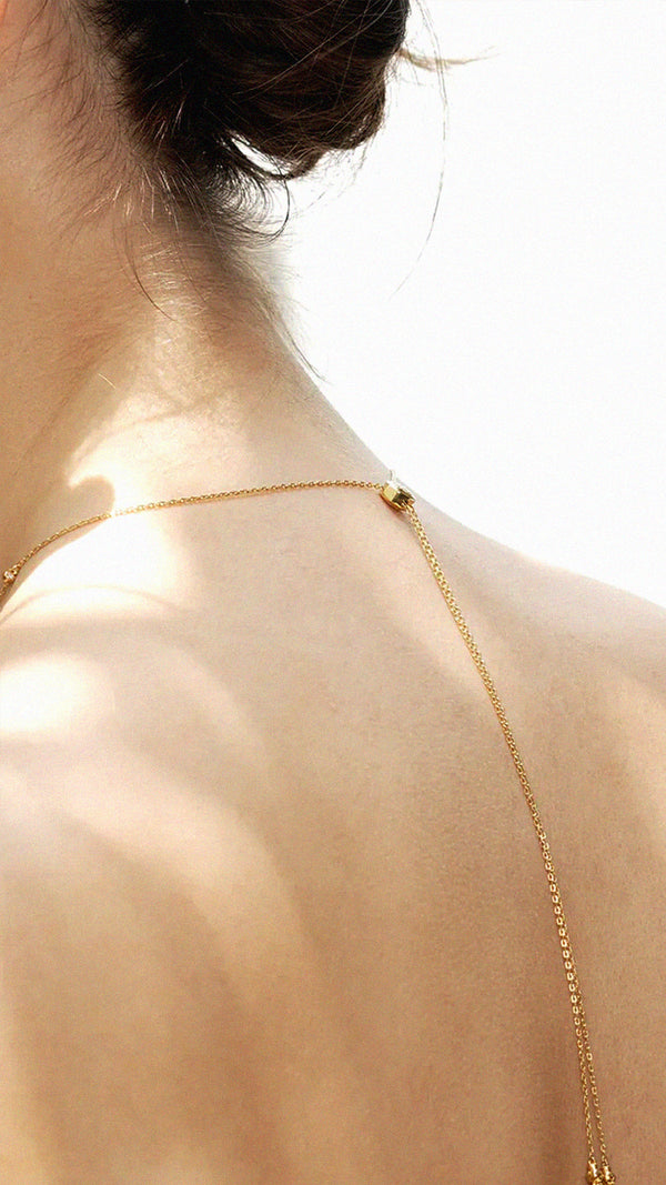 Gold necklace with an adjustable slider for the perfect placement. 