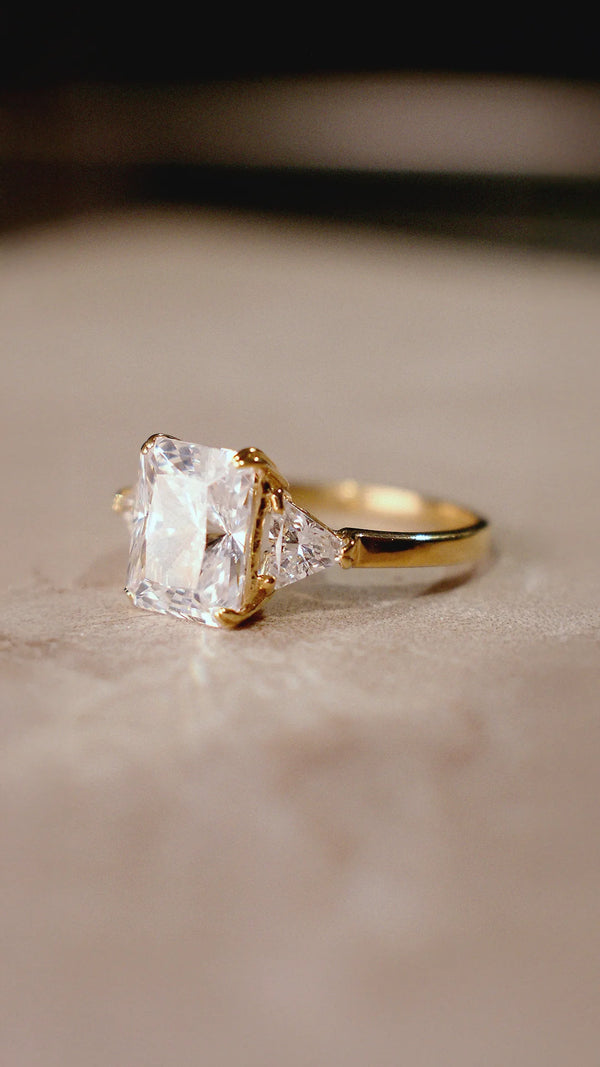 Radiant cut trilogy ring for women on a gold vermeil band.
