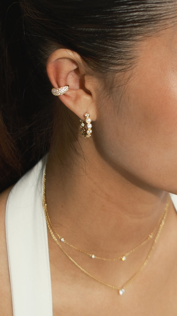 Gold round gemstones hoop earrings paired with a pave setting ear cuff earring in gold