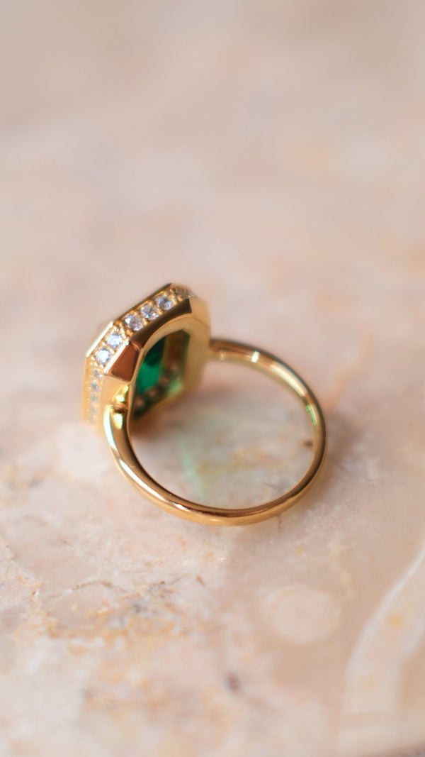 Back view of a gold vermeil chunky cocktail ring with an emerald keystone and pave microsettings