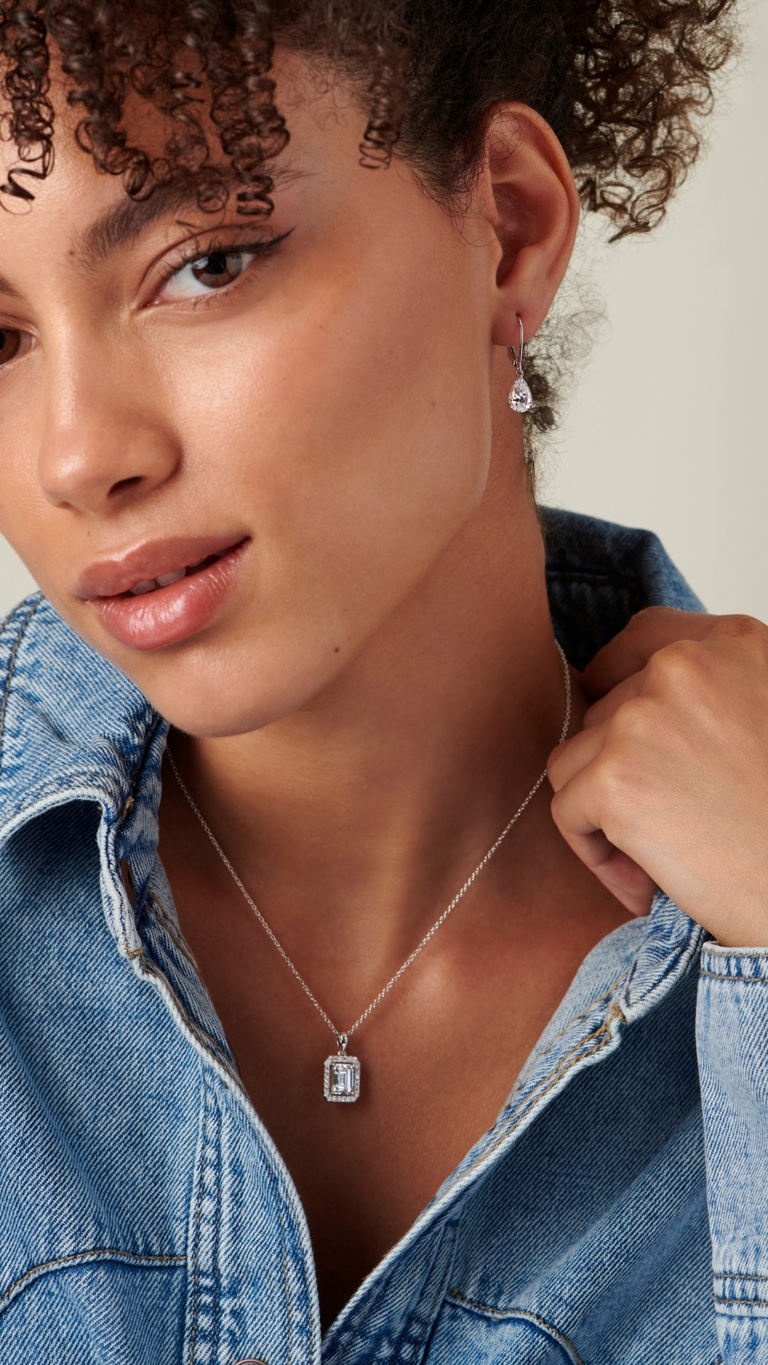 Finely cut pear diamond look earrings in solid white gold with a lever back.