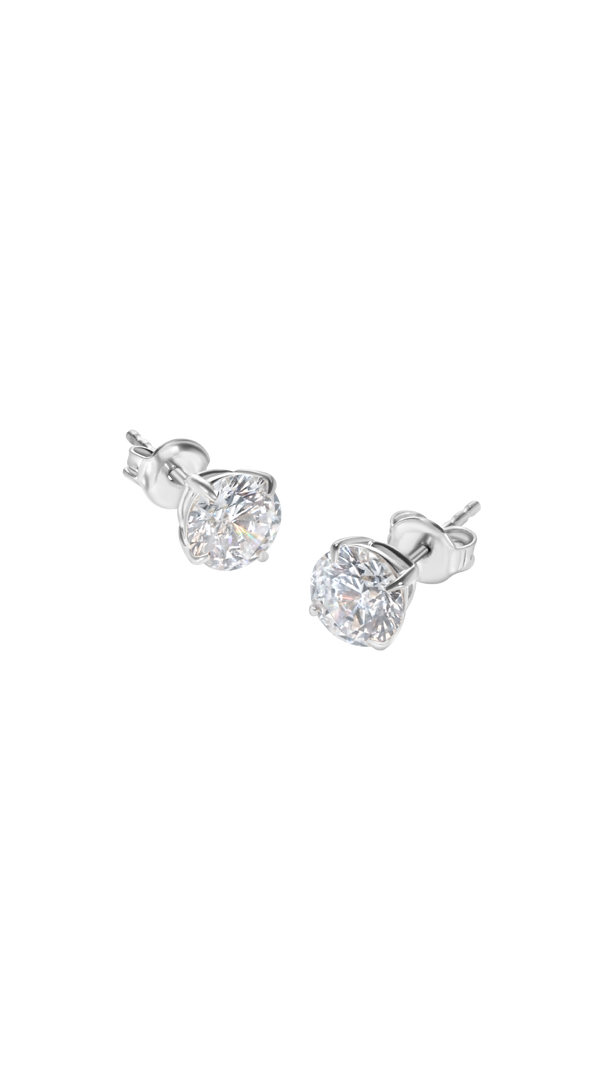 Minimalist 4-prong diamond studs in polished solid white gold.