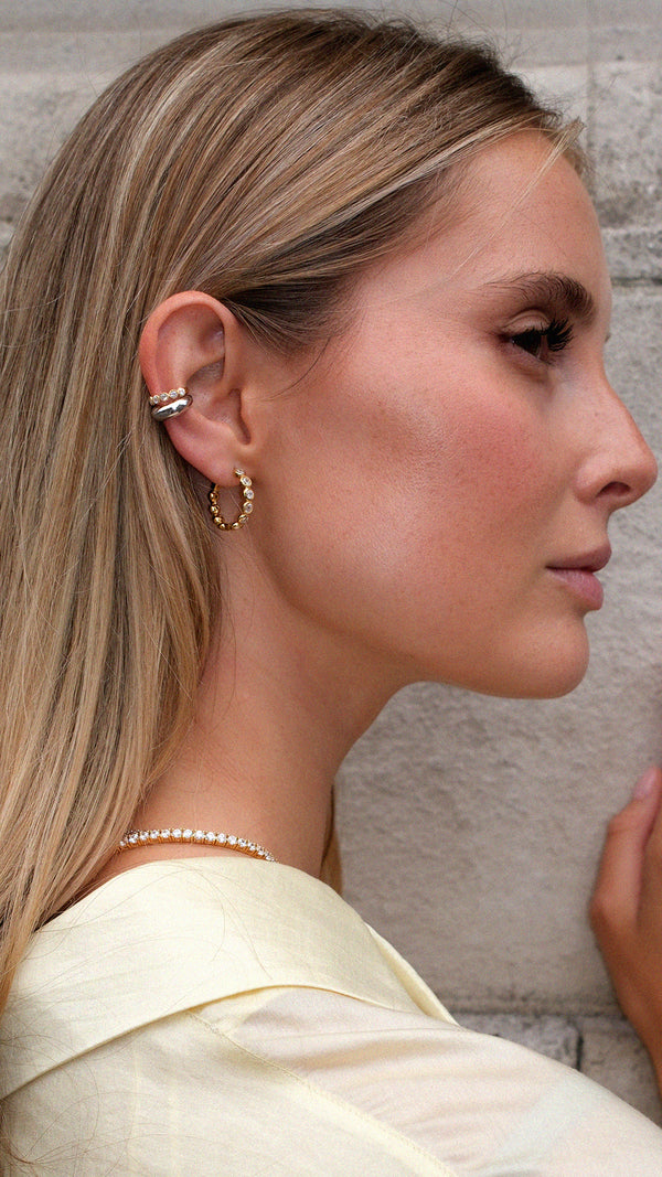 Mixed metal ear stack with gold vermeil and sterling silver ear cuffs layered together. 