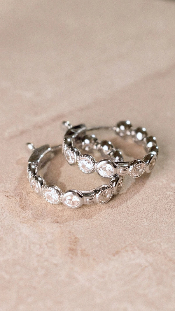 Close up of rhodium plated silver hoops showing the secure locking clasp mechanism.