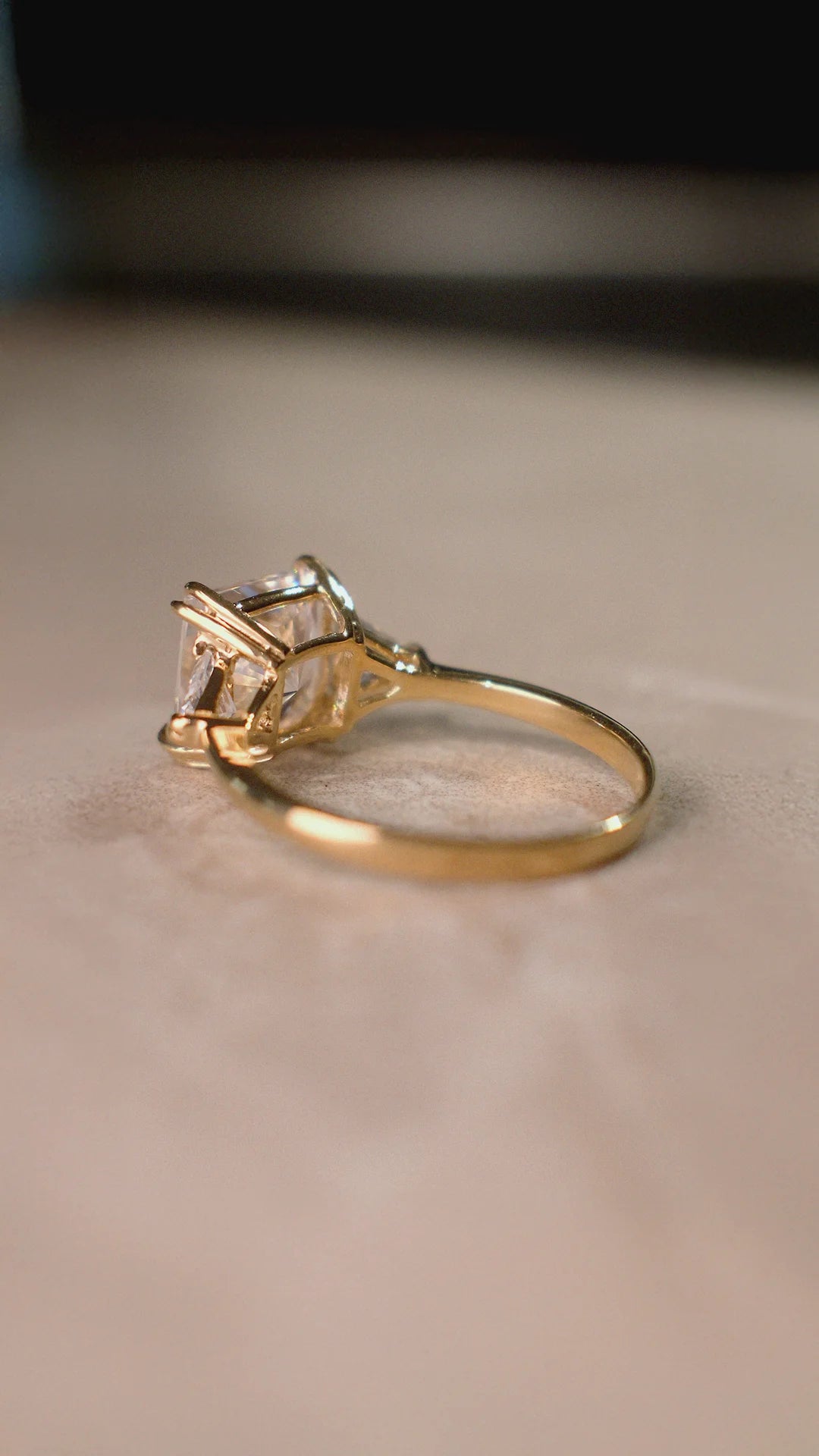 Gold trilogy ring for women with sparkling side stones.