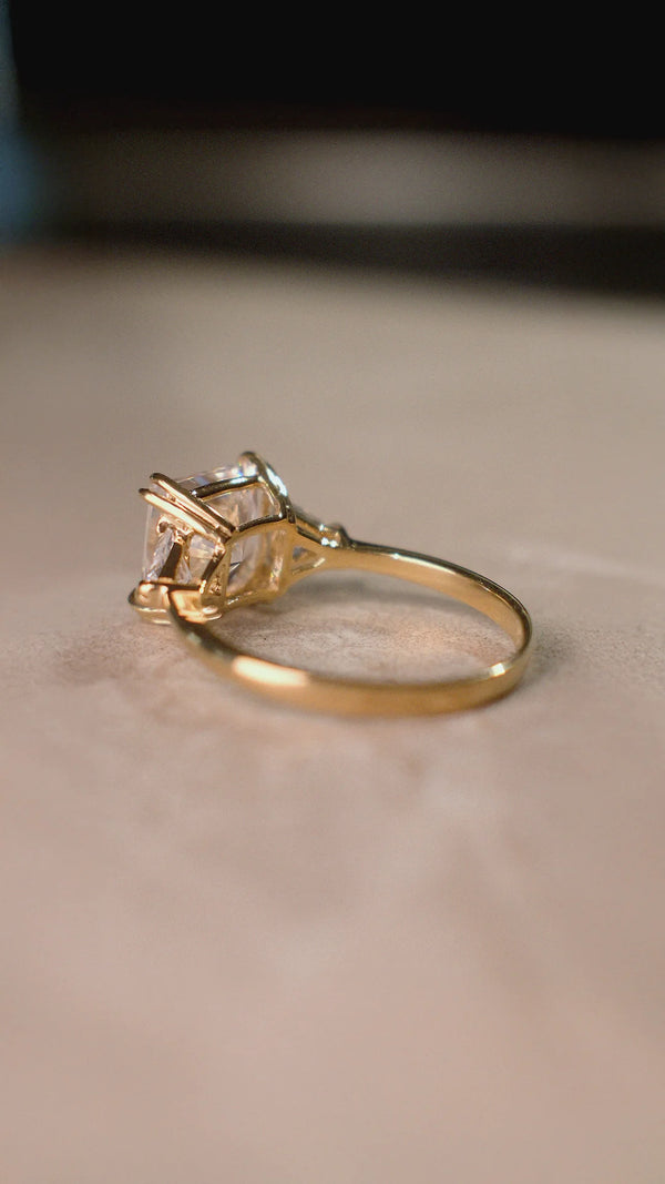 Gold trilogy ring for women with sparkling side stones.