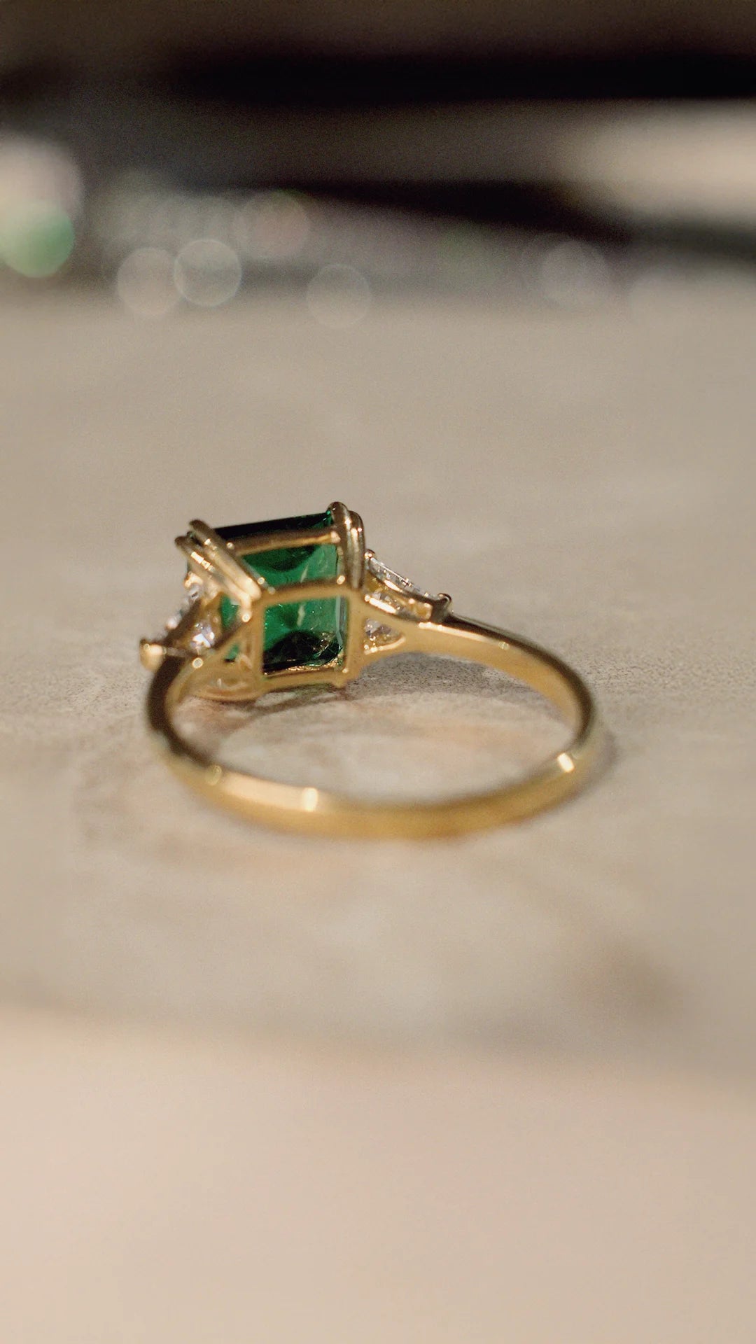 Gold ring with an emerald green gemstone   and gold vermeil on sterling silver band.