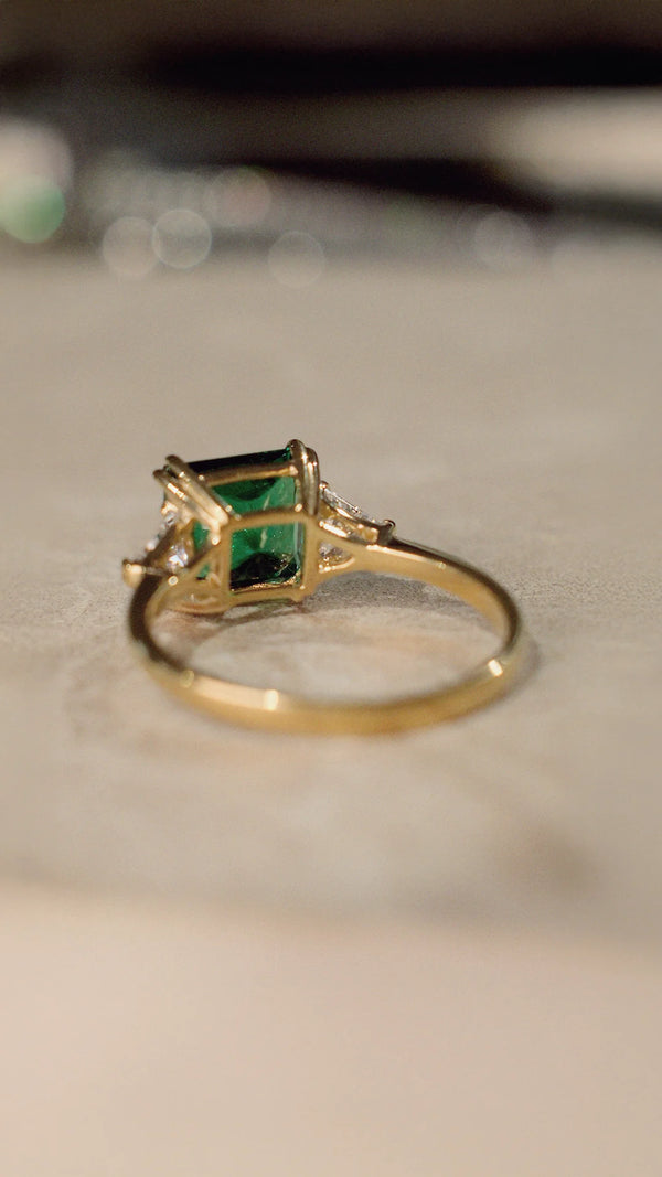 Gold ring with an emerald green gemstone   and gold vermeil on sterling silver band.