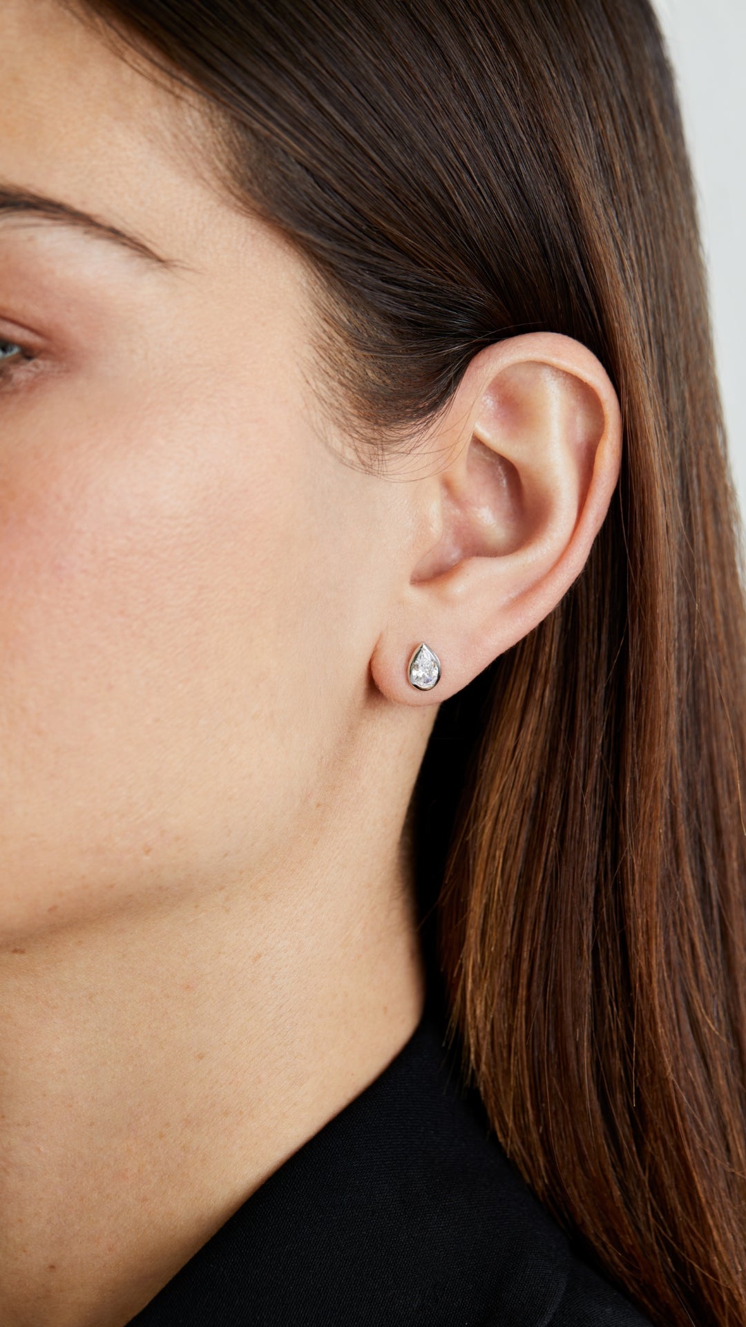 Simple sterling silver pear cut bezel stud earrings for women.