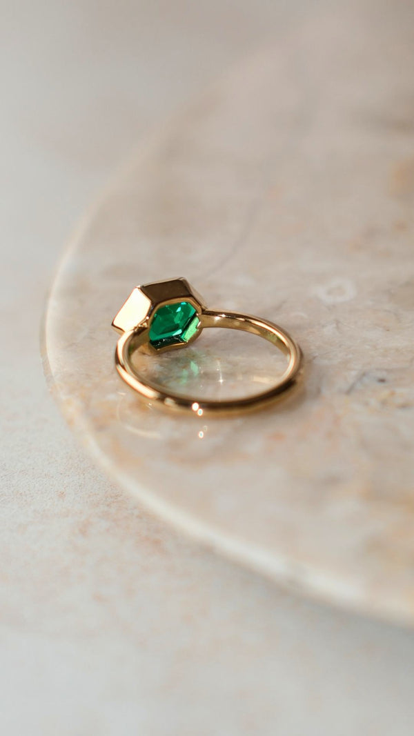 Gold vermeil ring with a lab-grown emerald gemstone in a hexagonal cut.