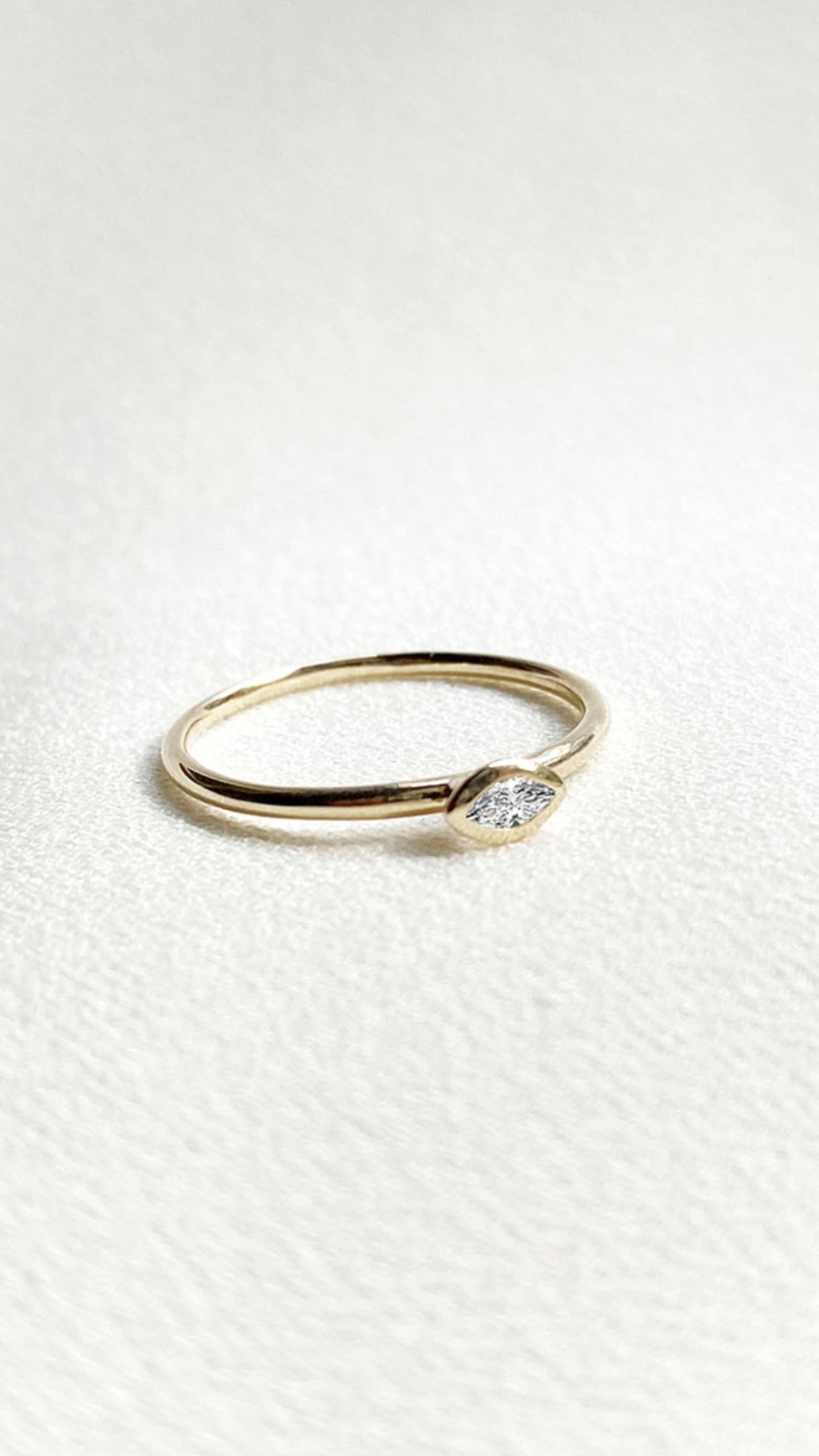 Minimalist solid gold ring with lab grown marquise diamond.
