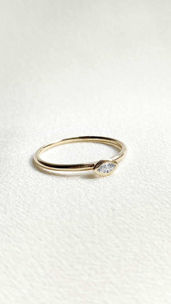 Minimalist solid gold ring with lab grown marquise diamond.