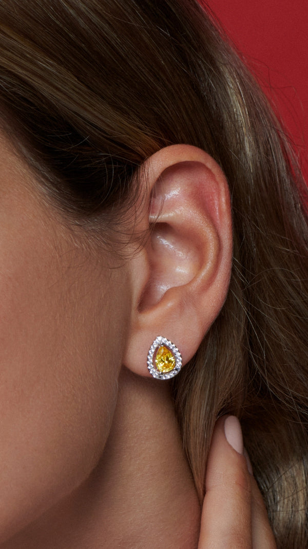 White gold plated sterling silver pear studs with yellow stone