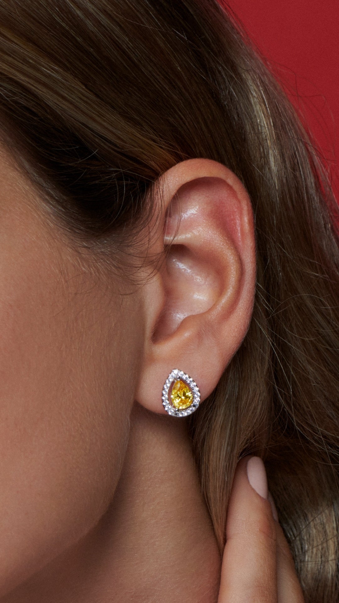 White gold plated sterling silver pear studs with yellow stone