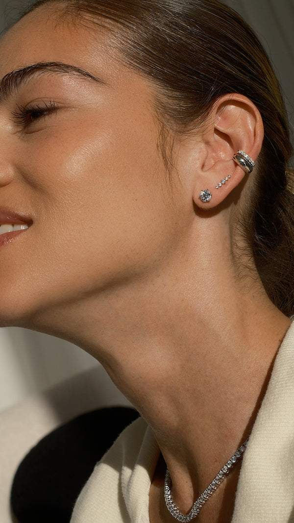 Curated sterling silver ear stack featuring a silver cuff and diamond style silver studs.