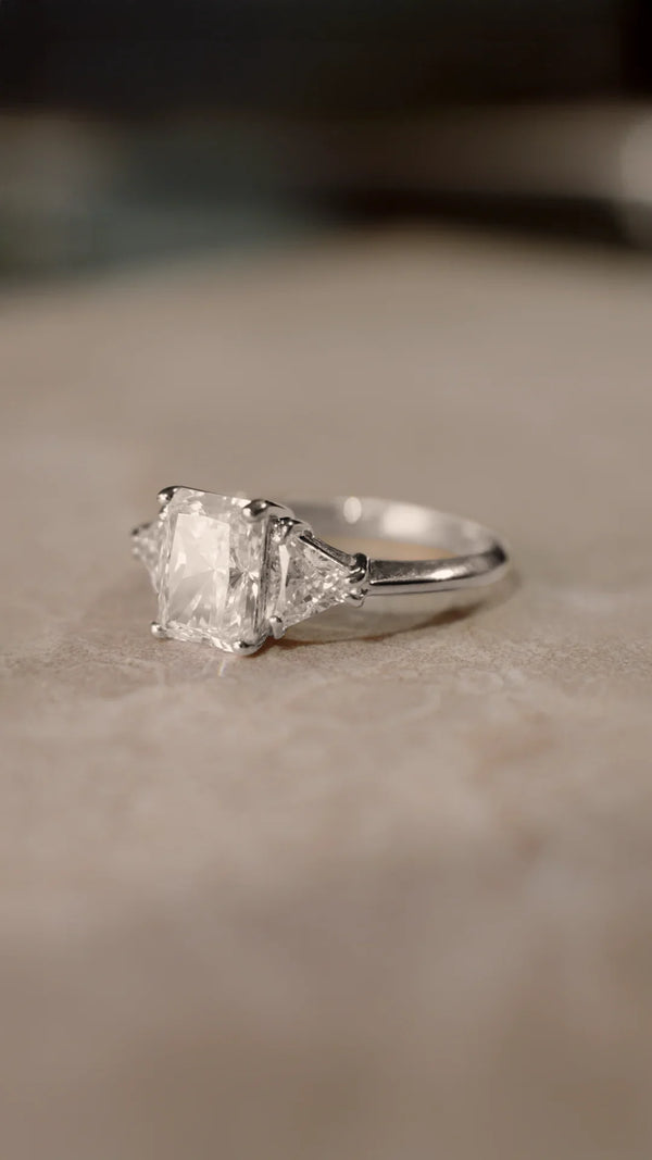 Sterling silver radiant cut trilogy ring for women.