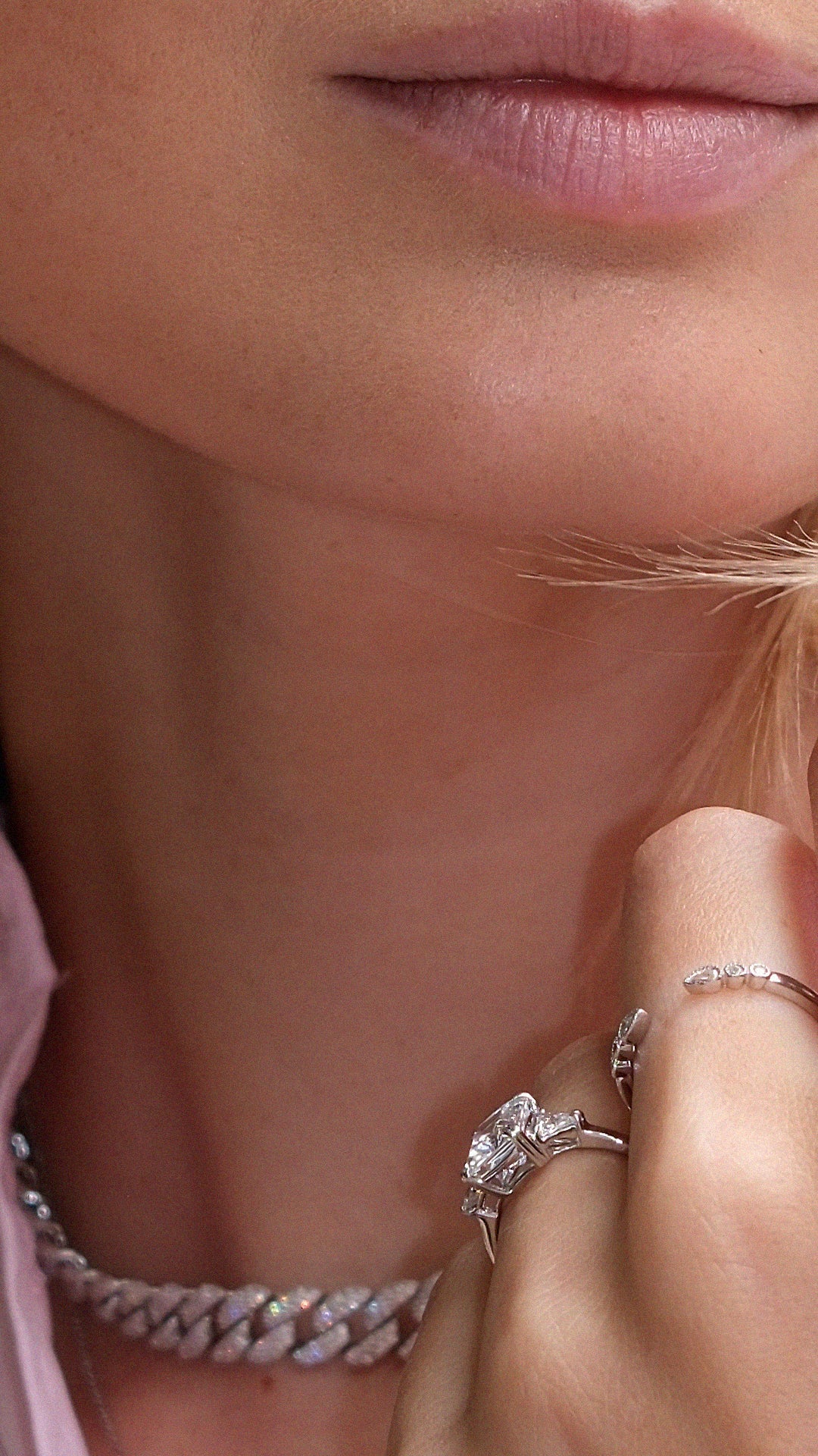 Close-up of a woman's wearing two sterling silver rings with diamond style accents.