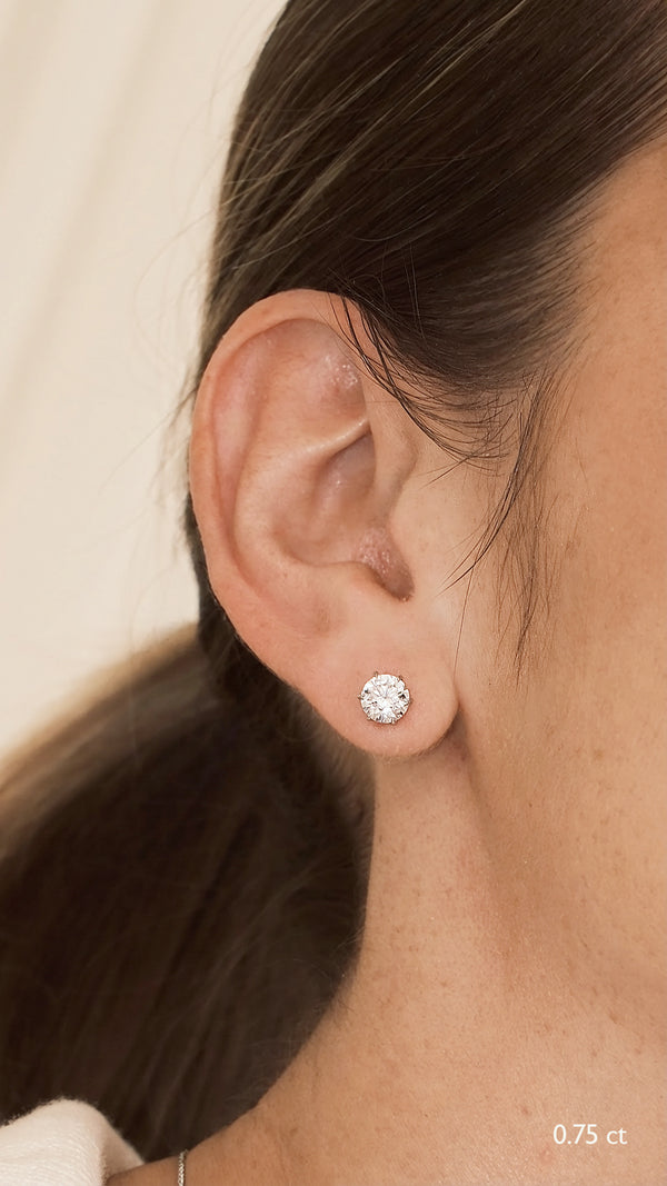 Close-up of an ear wearing a diamond style 0.75ct stud earring in white gold