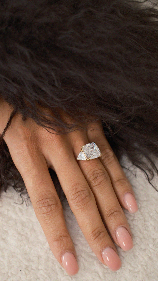 Three-stone trilogy ring set in polished gold vermeil.