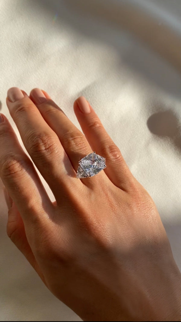 7ct eq. cushion cut trilogy ring in sterling silver with three-stone design.