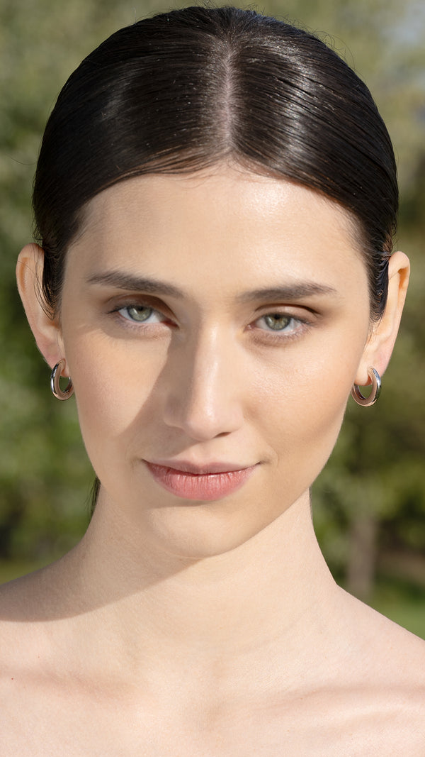 Modern, polished hoop earrings in sterling silver for women. 