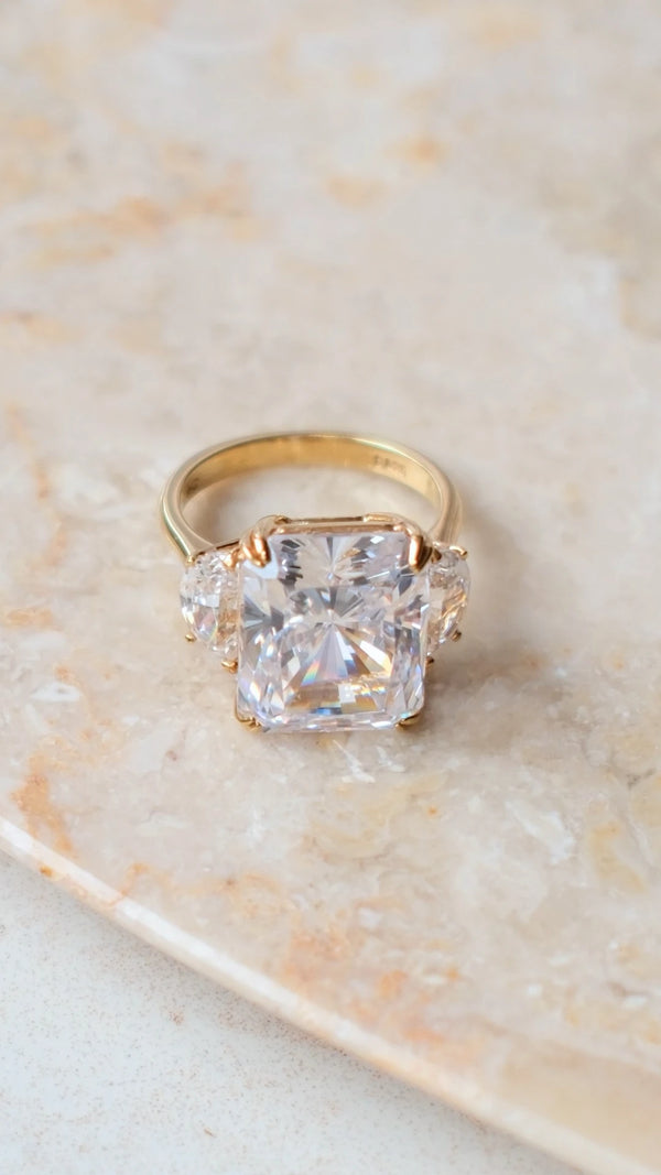 High-brilliance radiant cut stone showing light-refracting facets in gold setting.