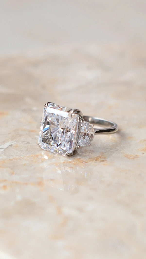 Side profile of a 7ct radiant cut ring showing the half-moon side stones.
