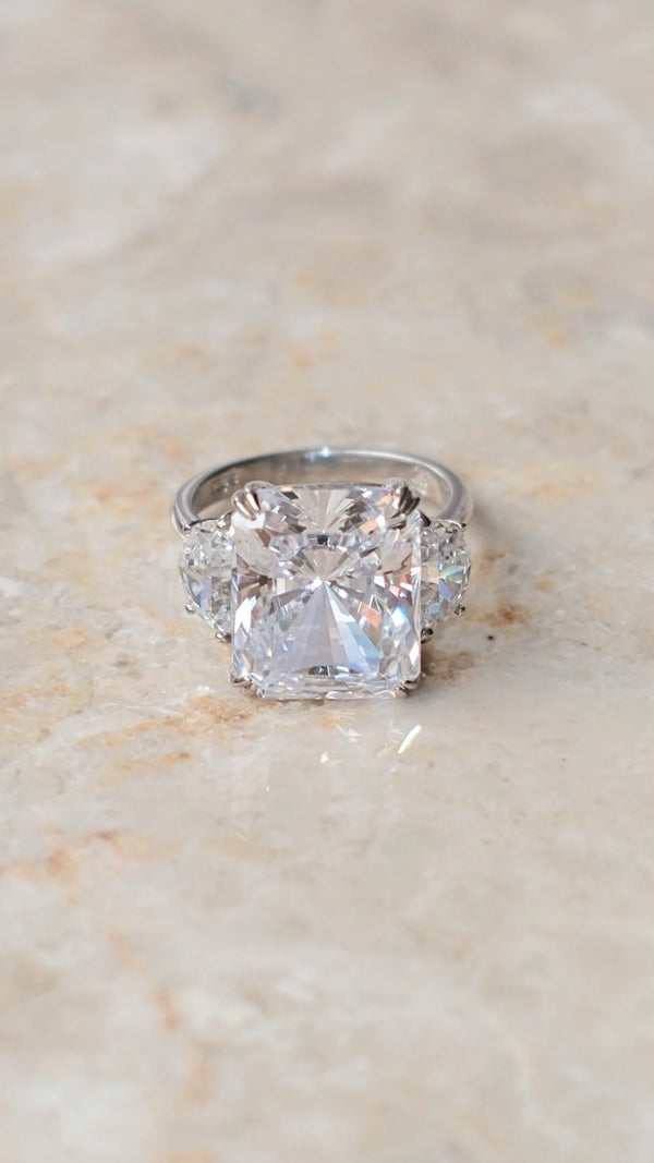 Three-stone sterling silver ring featuring a large radiant cut center stone.