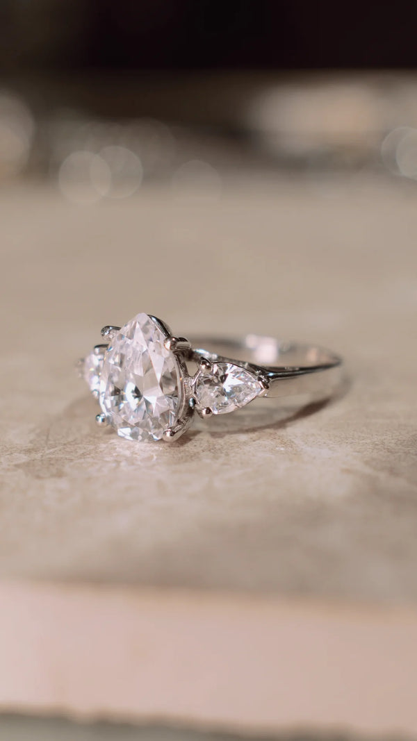 2ct diamond style ring with pear-shaped centre stone and smaller stones in solid 9k white gold. 