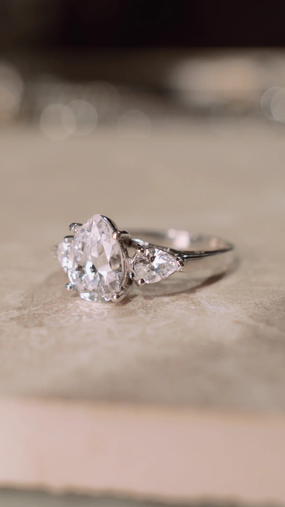 2ct diamond style ring with pear-shaped centre stone and smaller stones in solid 9k white gold. 