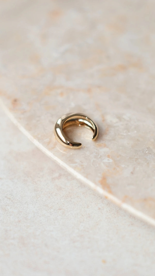 Back view of a sterling silver base ear cuff with a thick gold vermeil layer.