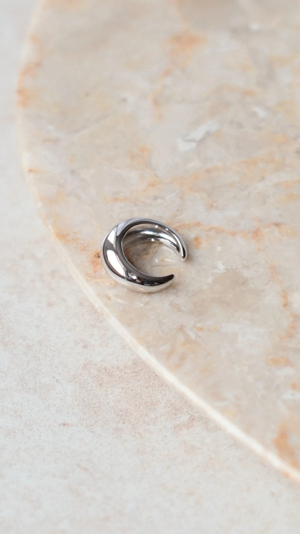 Close-up of a back view of a  polished sterling silver ear cuff for women.