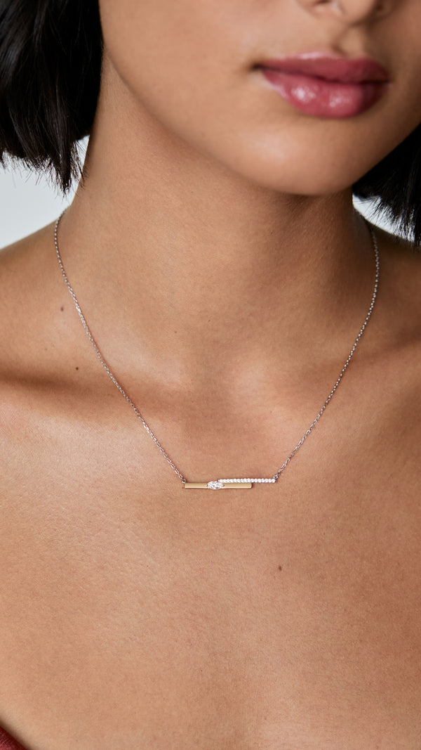 Mixed metal necklace with marquise gemstone in gold and silver.