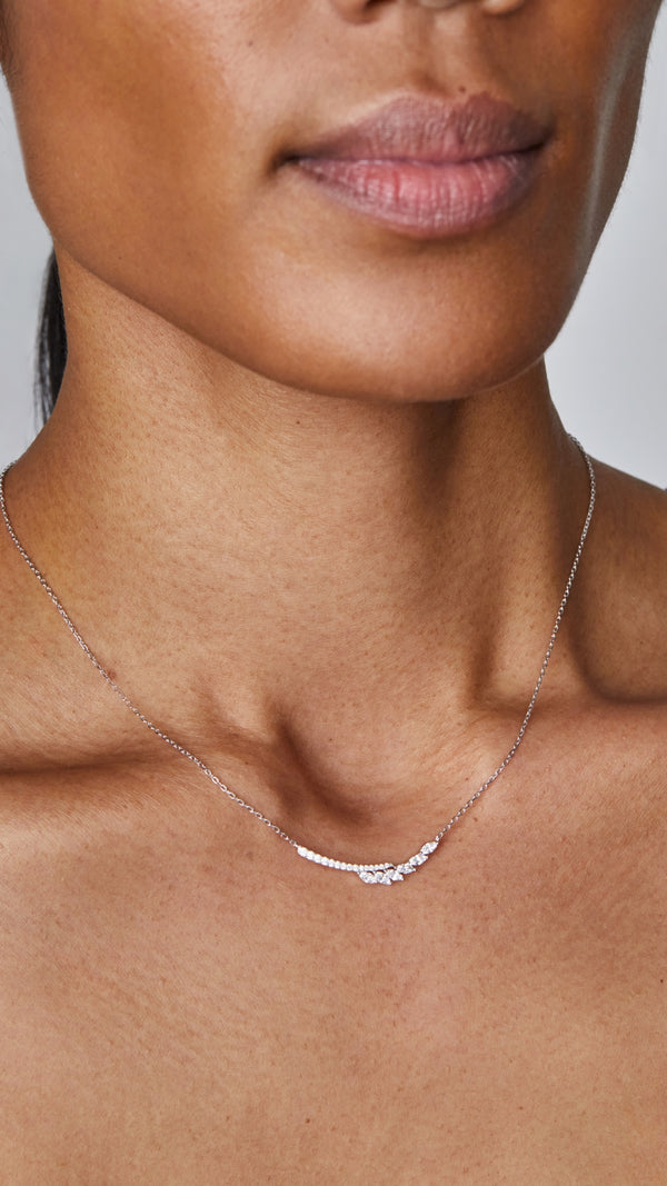 Delicate sterling silver pendant necklace, finished in white gold and embellished with a marquise-cut stones and micro-setting details.