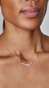 Delicate sterling silver pendant necklace, finished in white gold and embellished with a marquise-cut stones and micro-setting details.