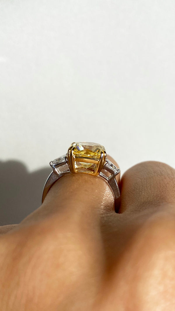 Silver ring showcasing a square-shaped modified brilliant yellow stone