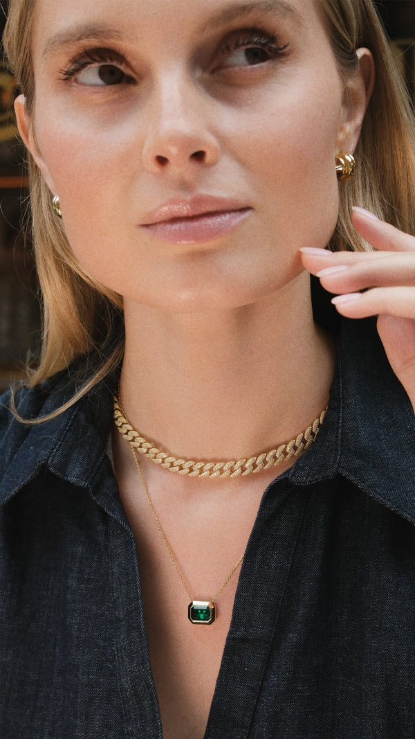 Emerald cut bezel pendant necklace layered with a gold chunk chain necklace.