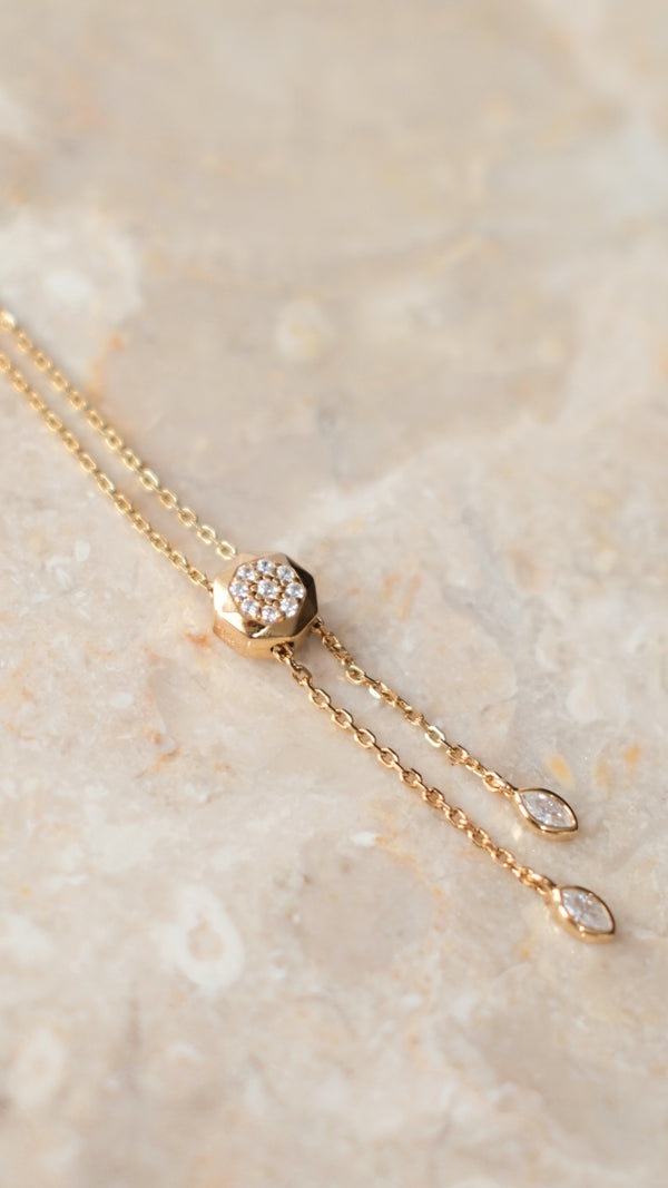 Gold vermeil adjustable slider necklace on a marble surface
