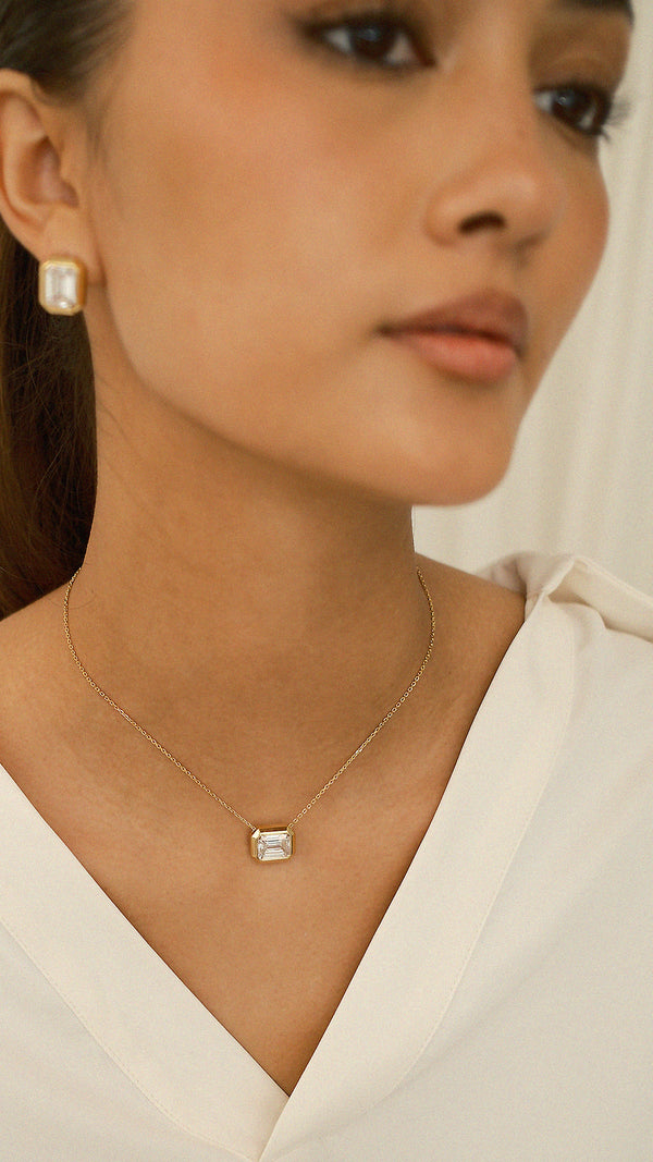 Gold Lily necklace with an emerald-cut pendant on a delicate adjustable gold chain.