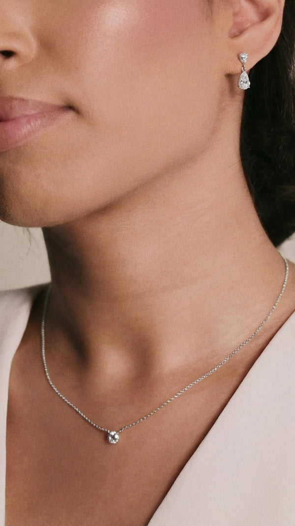 Minimalist single stone diamond pendant on a delicate white gold chain.