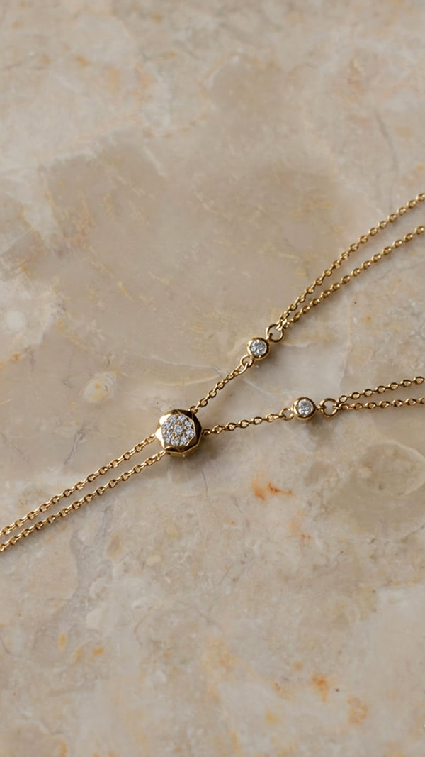 Gold pre-layered necklace signature slider pavé detailing.