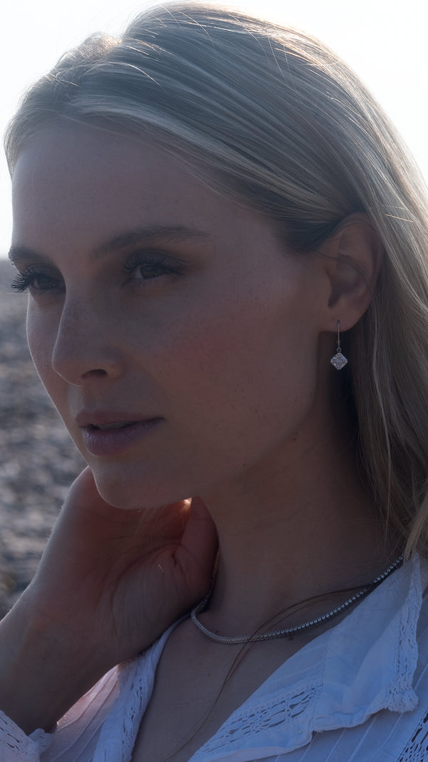 Close-up of square princess-cut crystals set in 9k solid white gold.