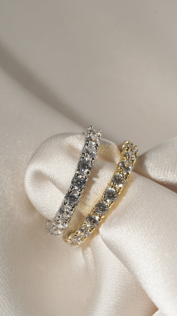 Solid white gold and solid yellow gold eternity rings placed side by side. 