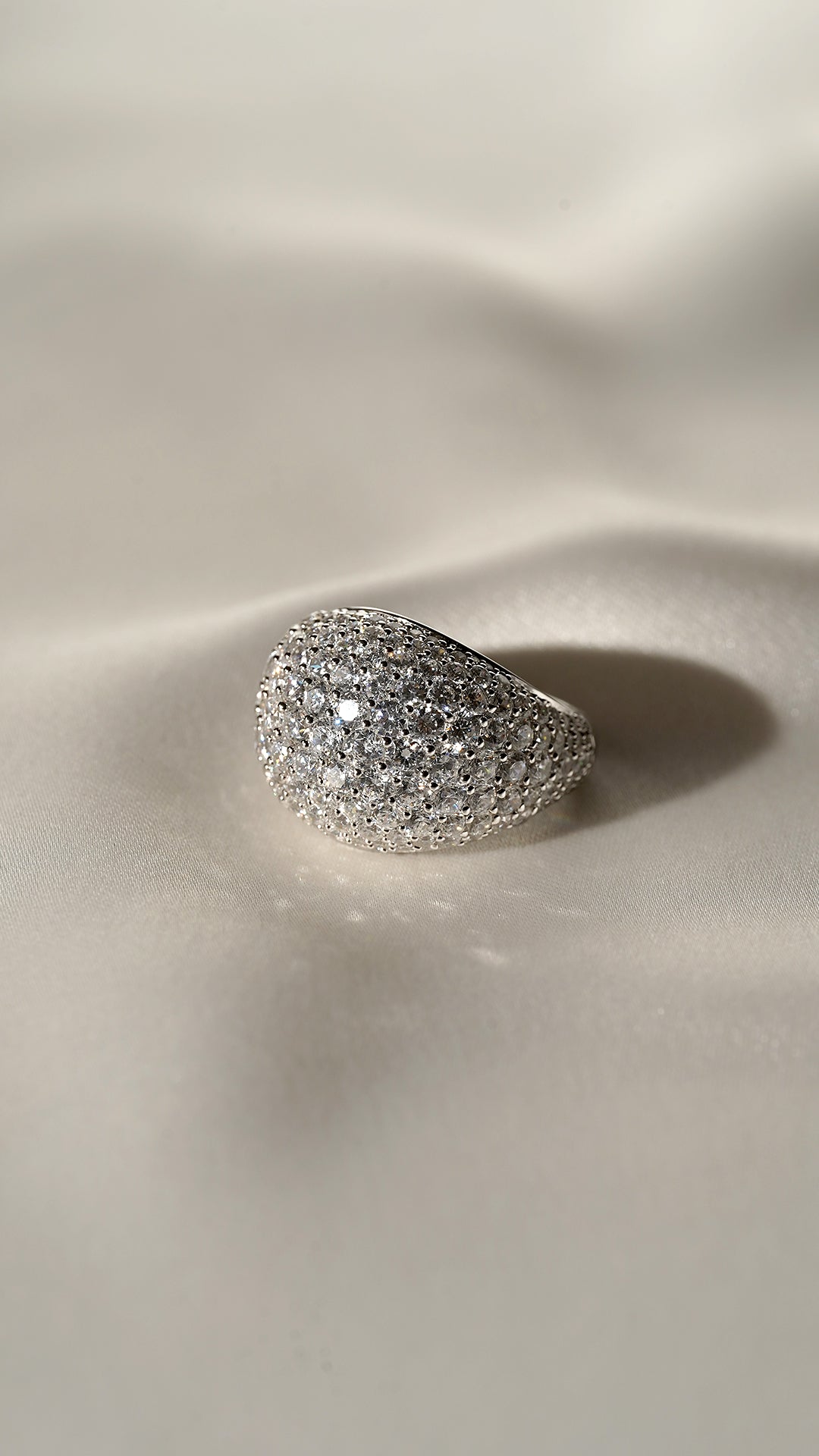Close-up of the Reese sterling silver dome ring, featuring a shimmering pave surface and a sleek, polished silver gallery.